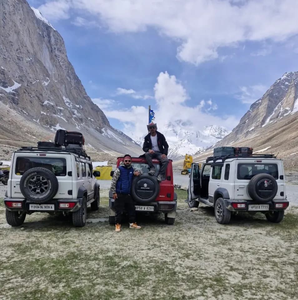 4x4 vehicles and travellers in a Himalayan valley